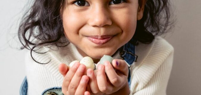 smiling hispanic girl with easter eggs