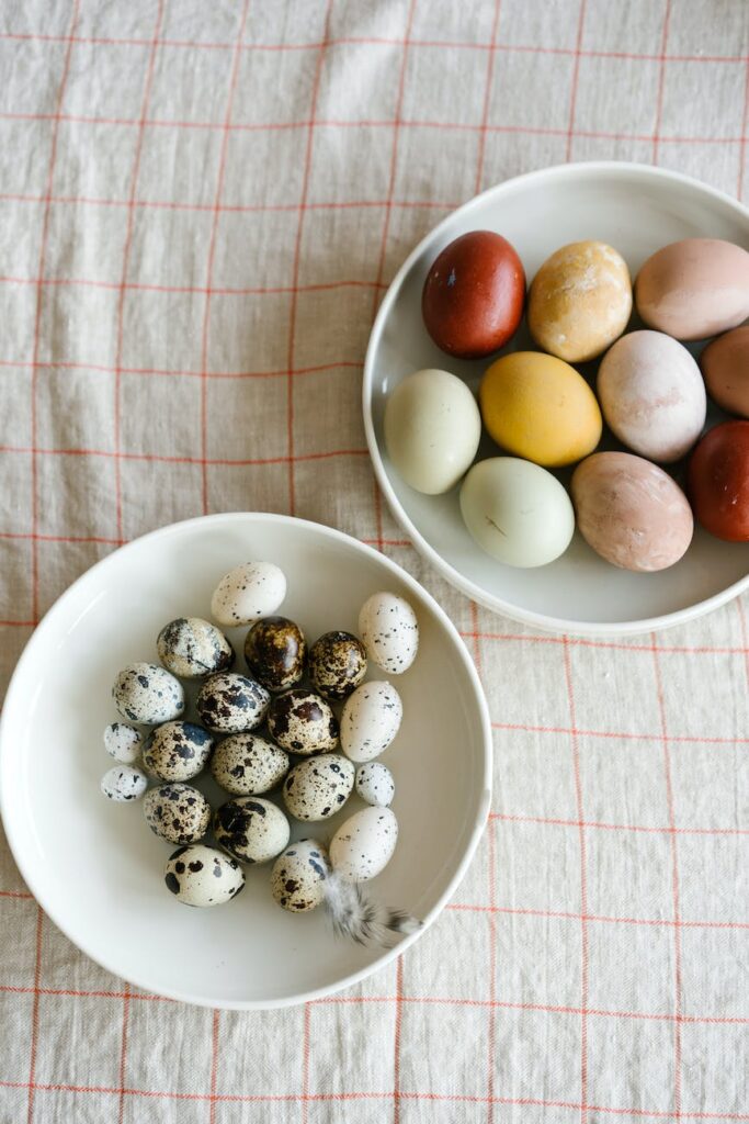 colorful eggs placed on plates on table